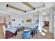 Elegant living room with tray ceilings with wood beams, custom built-ins, and comfortable seating at 16816 Seraphic Trl, Lakewood Ranch, FL 34211