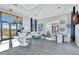 Bright and airy lobby with modern decor, large windows, and comfortable seating area at 16816 Seraphic Trl, Lakewood Ranch, FL 34211