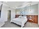 Relaxing main bedroom showcasing tray ceilings, decorative lighting, and wood accent wall at 16816 Seraphic Trl, Lakewood Ranch, FL 34211