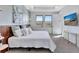 Inviting main bedroom offering a comfortable bed, wood accent wall, and a wall mounted television at 16816 Seraphic Trl, Lakewood Ranch, FL 34211
