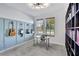Functional office space with lots of natural light, built-in bookshelves, and guitar decor at 16816 Seraphic Trl, Lakewood Ranch, FL 34211