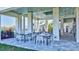 Inviting covered outdoor seating area with multiple tables and chairs for relaxation at 16816 Seraphic Trl, Lakewood Ranch, FL 34211