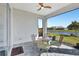 Covered patio with brick flooring, ceiling fan, and outdoor dining set overlooking the water at 16816 Seraphic Trl, Lakewood Ranch, FL 34211