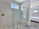 Sleek shower featuring gray tiled walls, glass enclosure, and a built-in bench at 16816 Seraphic Trl, Lakewood Ranch, FL 34211