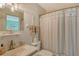 Nautical themed bathroom featuring a shower with seashell-patterned curtain and seashell decorations throughout at 1783 Lake Pl # 1783C, Venice, FL 34293