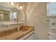 Bathroom with large mirror, granite counter and ample lighting at 1783 Lake Pl # 1783C, Venice, FL 34293