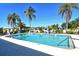 Large community pool with sun loungers and palm trees, providing a resort-like experience for residents at 1783 Lake Pl # 1783C, Venice, FL 34293