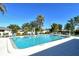 Sparkling community pool surrounded by ample lounge chairs, perfect for relaxing and enjoying sunny days at 1783 Lake Pl # 1783C, Venice, FL 34293