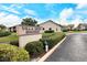 Attractive community sign for Villa Nova Shores set amidst manicured landscaping and clear skies at 1783 Lake Pl # 1783C, Venice, FL 34293