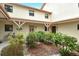 Picturesque courtyard showcasing manicured bushes and a bicycle in front of the condo entrance at 1783 Lake Pl # 1783C, Venice, FL 34293
