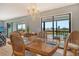 Elegant dining room with sliding glass doors leading to the screened lanai at 1783 Lake Pl # 1783C, Venice, FL 34293