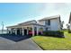Exterior of condo featuring covered parking for multiple cars and well-maintained landscaping at 1783 Lake Pl # 1783C, Venice, FL 34293