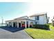 Exterior of condo featuring covered parking for multiple cars and well-maintained landscaping at 1783 Lake Pl # 1783C, Venice, FL 34293