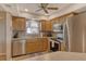 Modern kitchen features stainless steel appliances, granite countertops, and wood cabinets at 1783 Lake Pl # 1783C, Venice, FL 34293