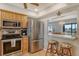 Kitchen offers stainless appliances, a breakfast bar, and an open view of the dining area at 1783 Lake Pl # 1783C, Venice, FL 34293
