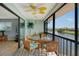 Cozy lanai featuring tile flooring, ceiling fan, and stunning water views at 1783 Lake Pl # 1783C, Venice, FL 34293