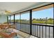 Enclosed lanai with tile flooring, ceiling fan, and gorgeous views of the canal at 1783 Lake Pl # 1783C, Venice, FL 34293