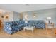 Open-concept living room with seaside-themed decor and wood flooring at 1783 Lake Pl # 1783C, Venice, FL 34293