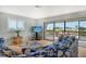 Bright living room with lanai access and a TV, alongside comfortable, beach-themed furnishings at 1783 Lake Pl # 1783C, Venice, FL 34293