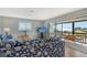 Cozy living room with ocean-themed decor, leading to a screened-in lanai with waterfront views at 1783 Lake Pl # 1783C, Venice, FL 34293
