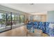 Inviting living room leads to lanai, featuring nautical-themed decor and waterfront views at 1783 Lake Pl # 1783C, Venice, FL 34293