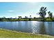 Picturesque water view showcasing waterfront homes and lush greenery under a clear blue sky at 1783 Lake Pl # 1783C, Venice, FL 34293