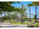 Community playground with slides, climbing ropes, and shaded seating areas for relaxation at 19912 Bridgetown Loop, Venice, FL 34293