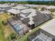 Aerial view of a home featuring a screened-in pool area and solar panels, nestled in a residential neighborhood at 19912 Bridgetown Loop, Venice, FL 34293