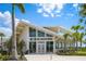 The Banyan House features a modern architectural style with large windows and a welcoming entrance at 19912 Bridgetown Loop, Venice, FL 34293