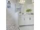 Bathroom featuring marble tiled shower, double vanity with white cabinets, and elegant finishes at 19912 Bridgetown Loop, Venice, FL 34293