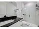 Modern bathroom featuring a glass shower, white tile, and black hardware at 19912 Bridgetown Loop, Venice, FL 34293
