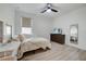 Bright bedroom features wood-look floors, ceiling fan, and a window for natural light at 19912 Bridgetown Loop, Venice, FL 34293