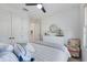 Bedroom featuring a ceiling fan, neutral colors, wood-look flooring, and abundant natural light at 19912 Bridgetown Loop, Venice, FL 34293