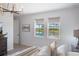 Bright bedroom overlooking outdoor views with plush bedding, accent lighting, and natural light at 19912 Bridgetown Loop, Venice, FL 34293