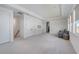 Large bonus room with plush carpet and a comfortable seating area at 19912 Bridgetown Loop, Venice, FL 34293