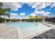 Community swimming pool with lounge chairs on sunny day at 19912 Bridgetown Loop, Venice, FL 34293