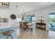 Well-lit dining area with access to the outdoor pool, complete with wine storage and modern decor at 19912 Bridgetown Loop, Venice, FL 34293