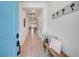 Bright and airy entryway featuring wood floors, a charming bench and elegant decor at 19912 Bridgetown Loop, Venice, FL 34293