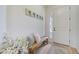 Bright foyer area with a rustic bench and decor, with natural light from door windows at 19912 Bridgetown Loop, Venice, FL 34293