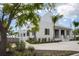 Beautiful two-story exterior features an architectural design with lush landscaping and a well-manicured lawn at 19912 Bridgetown Loop, Venice, FL 34293
