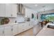 Modern kitchen featuring white cabinets, quartz countertops, stainless steel appliances, and decorative elements at 19912 Bridgetown Loop, Venice, FL 34293