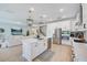 Contemporary kitchen with an island, stainless appliances, and open view to the living room at 19912 Bridgetown Loop, Venice, FL 34293