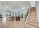 Spacious living room featuring an open layout, wood flooring, and lots of natural light at 19912 Bridgetown Loop, Venice, FL 34293