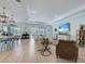 Bright living room featuring an open layout, wood flooring, and view to the lanai and bar at 19912 Bridgetown Loop, Venice, FL 34293