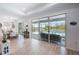 Open-concept living and dining space with a large sliding glass door to the outdoor pool area at 19912 Bridgetown Loop, Venice, FL 34293