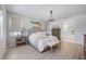 Comfortable main bedroom with neutral tones, soft lighting, and a view of the en-suite bathroom at 19912 Bridgetown Loop, Venice, FL 34293