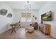Home office with desk, comfortable chair, stylish decor, and ample natural light at 19912 Bridgetown Loop, Venice, FL 34293
