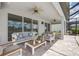 Stylish covered patio with comfortable seating, ideal for relaxing and enjoying the outdoor views and a cool breeze at 19912 Bridgetown Loop, Venice, FL 34293