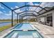Lush backyard with a screened-in pool, jacuzzi, and expansive lake view, offering a private outdoor retreat at 19912 Bridgetown Loop, Venice, FL 34293