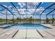 Sparkling screened-in pool and spa with a beautiful lake view, perfect for relaxation and entertainment at 19912 Bridgetown Loop, Venice, FL 34293